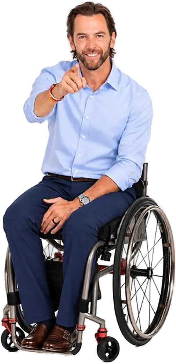 Tom Morris, keynote speaker, smiling and pointing toward the camera from his wheelchair