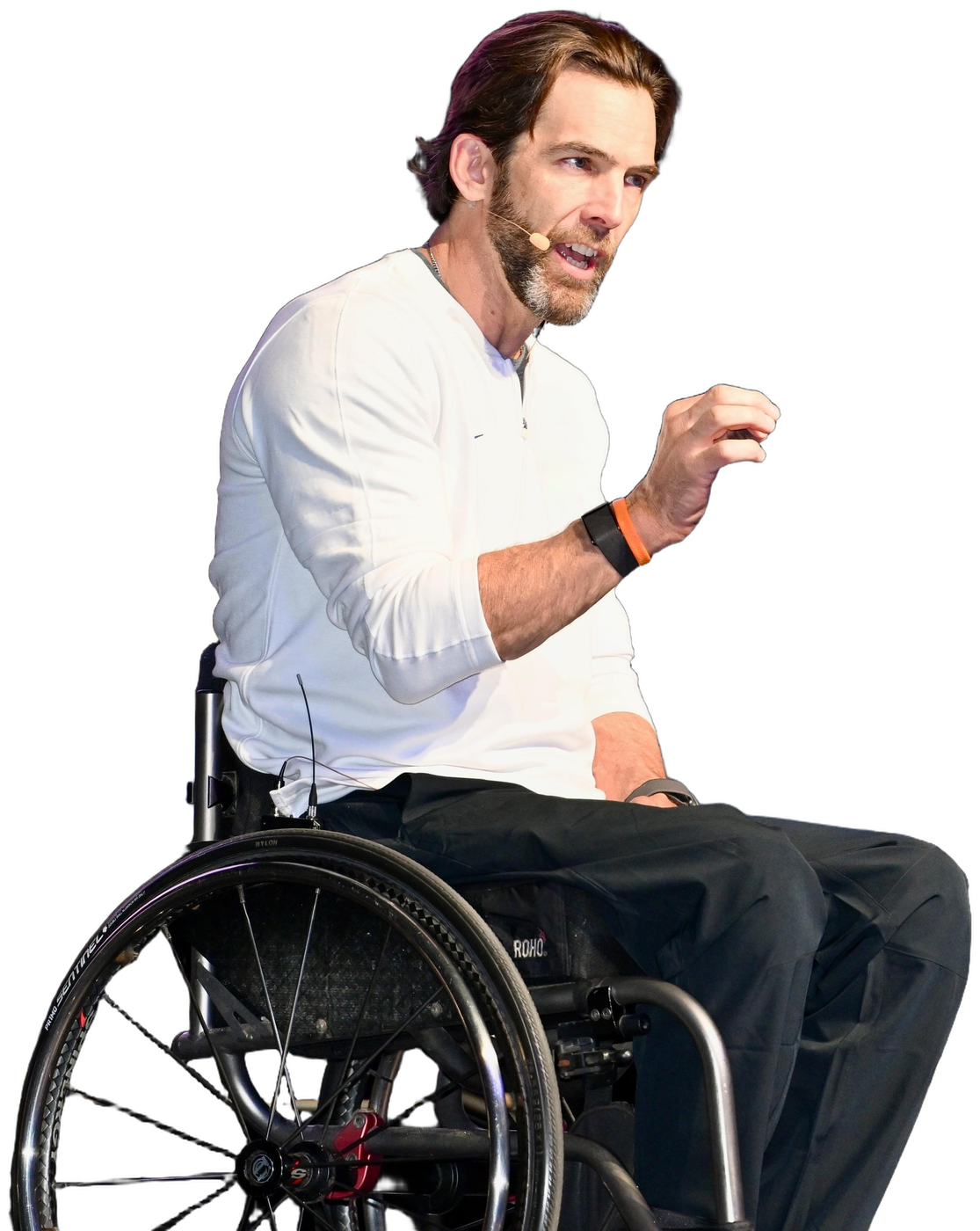 Tom Morris speaking from his wheelchair, gesturing toward the headline